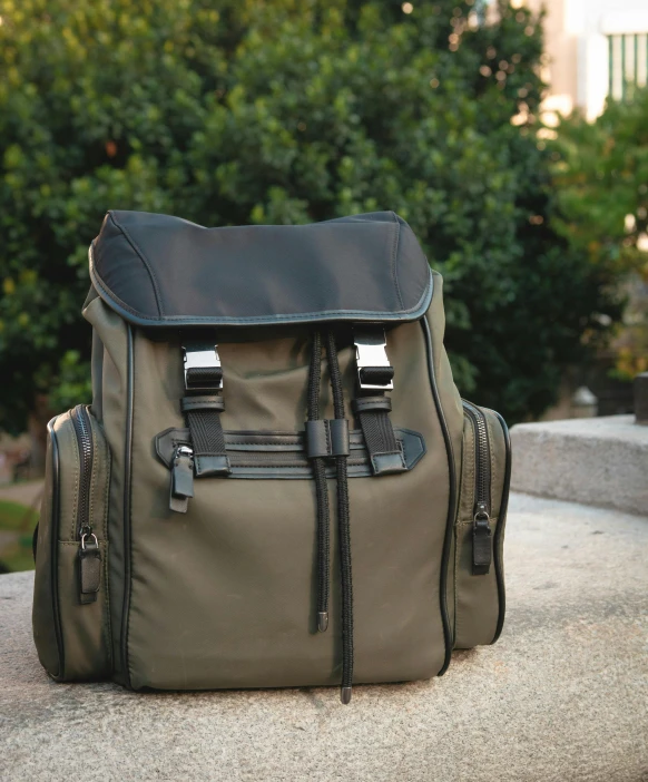 a brown canvas backpack with two large zips on it