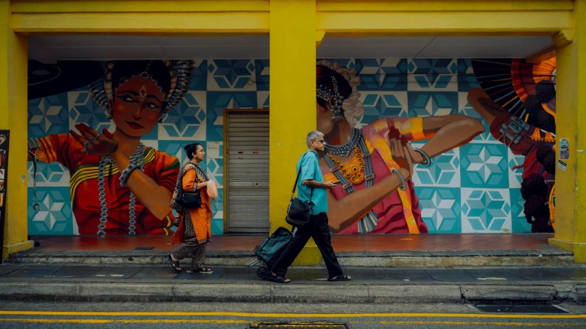 the side of a building with some people walking past