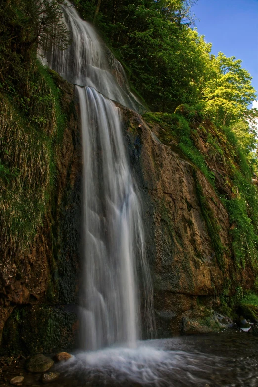 a waterfall in a lush green forest