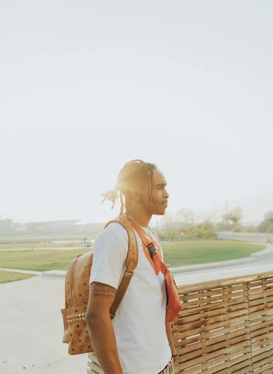 a person with dreadlocks walks down a sidewalk