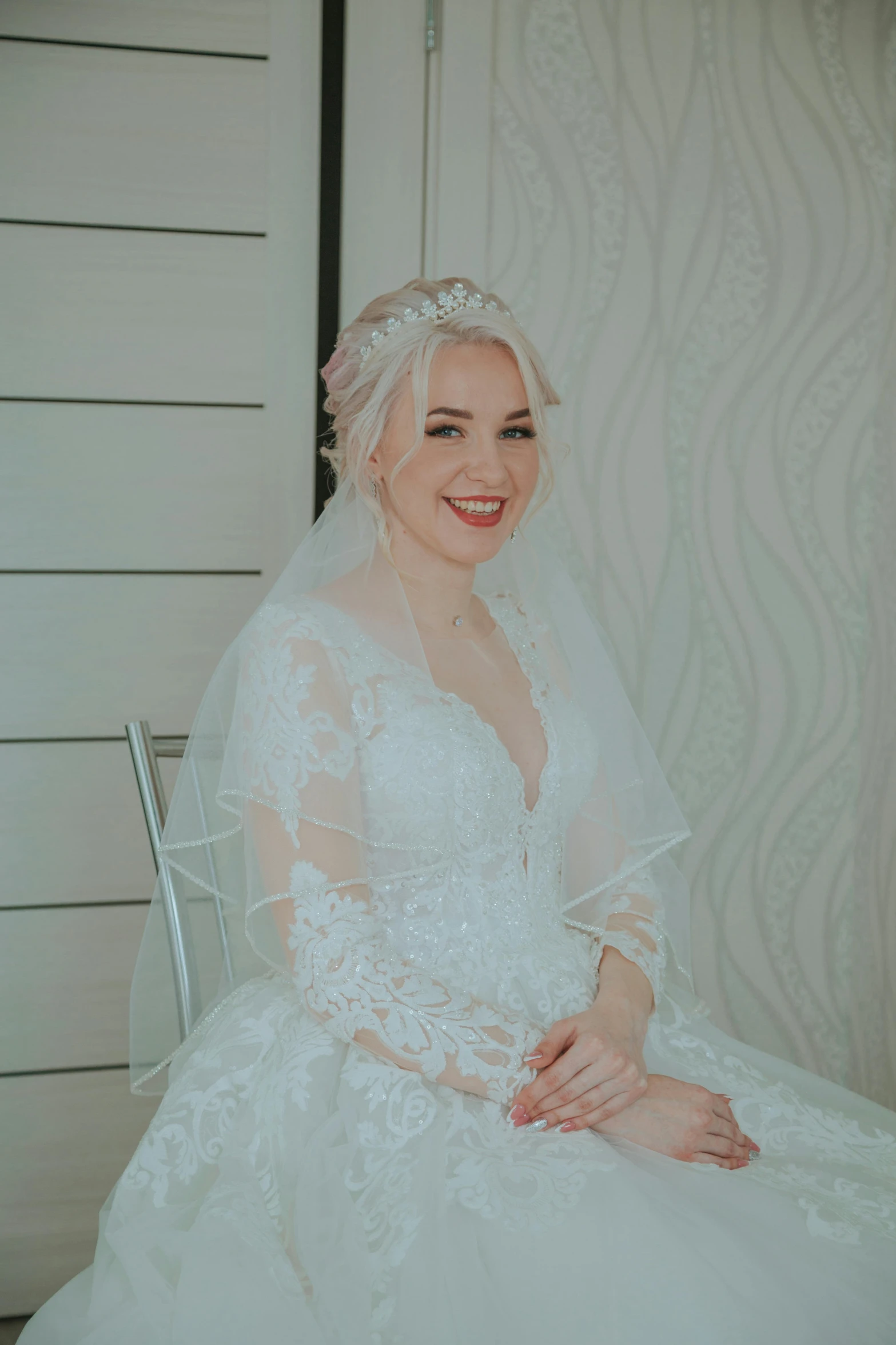 a woman sitting down in a wedding dress