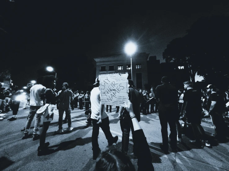 protesters hold signs and wave at the police