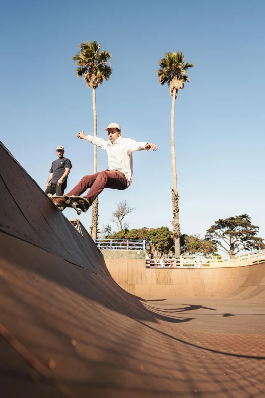 two boys riding their skateboards up a ramp