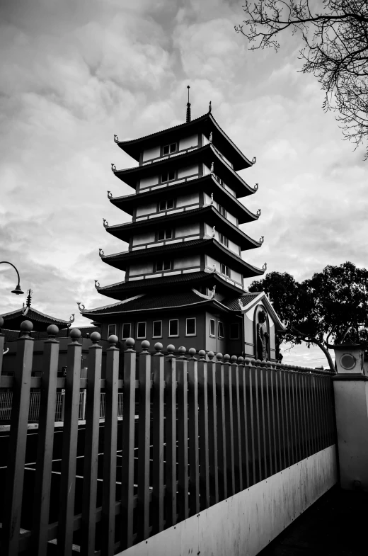 a tall tower sitting next to a fence