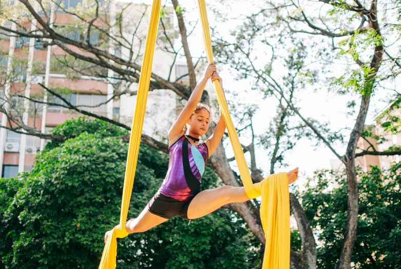 a woman on a high ropes doing yoga