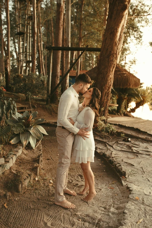 couple posing for a picture in the woods