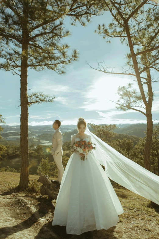 a man and woman are getting married on top of a hill