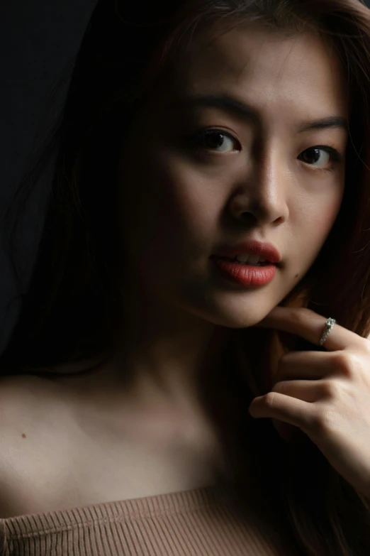 a woman posing with an open ring on her finger