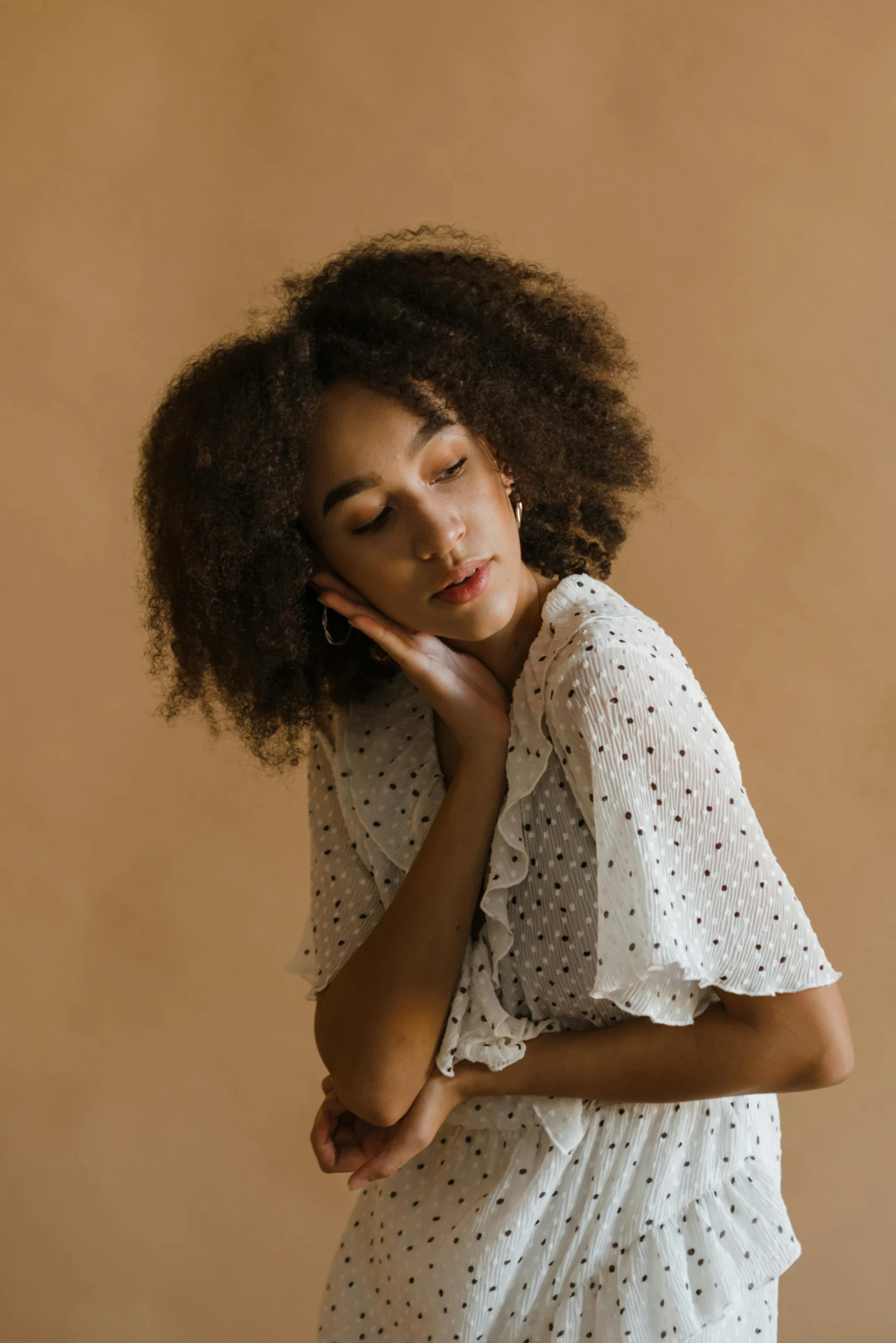 a woman in a white dress is leaning against her head