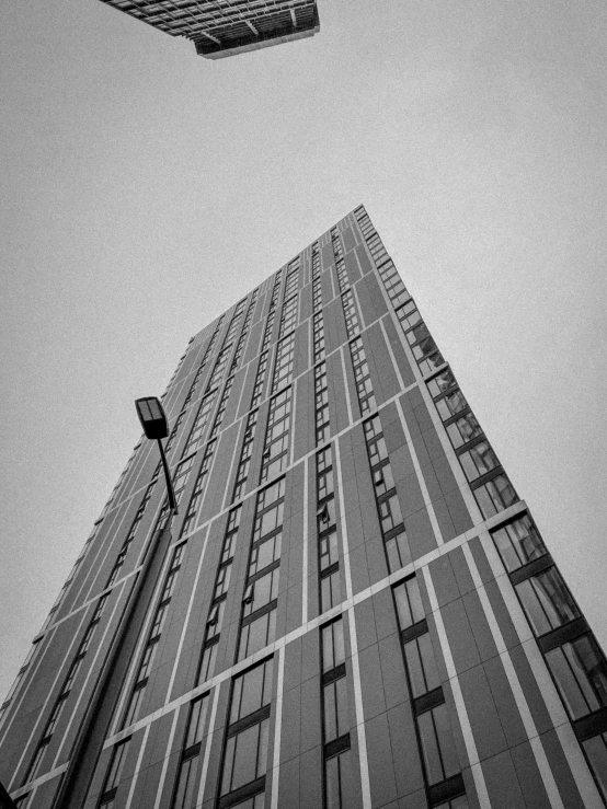 two tall buildings next to each other under a white sky