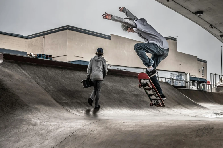 the young skateboarder jumps high in the air to keep the balance