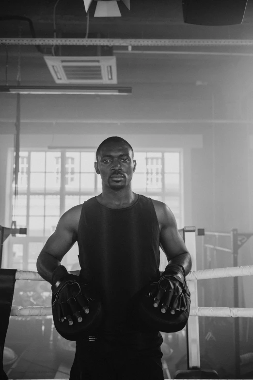 the boxer standing in a boxing ring wearing protective gloves