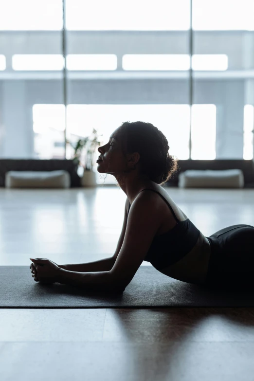 a woman doing a yoga pose in an open area