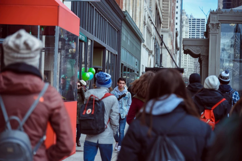 a group of people are walking down the street