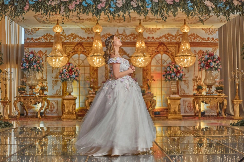 a woman standing inside of a building wearing a princess gown