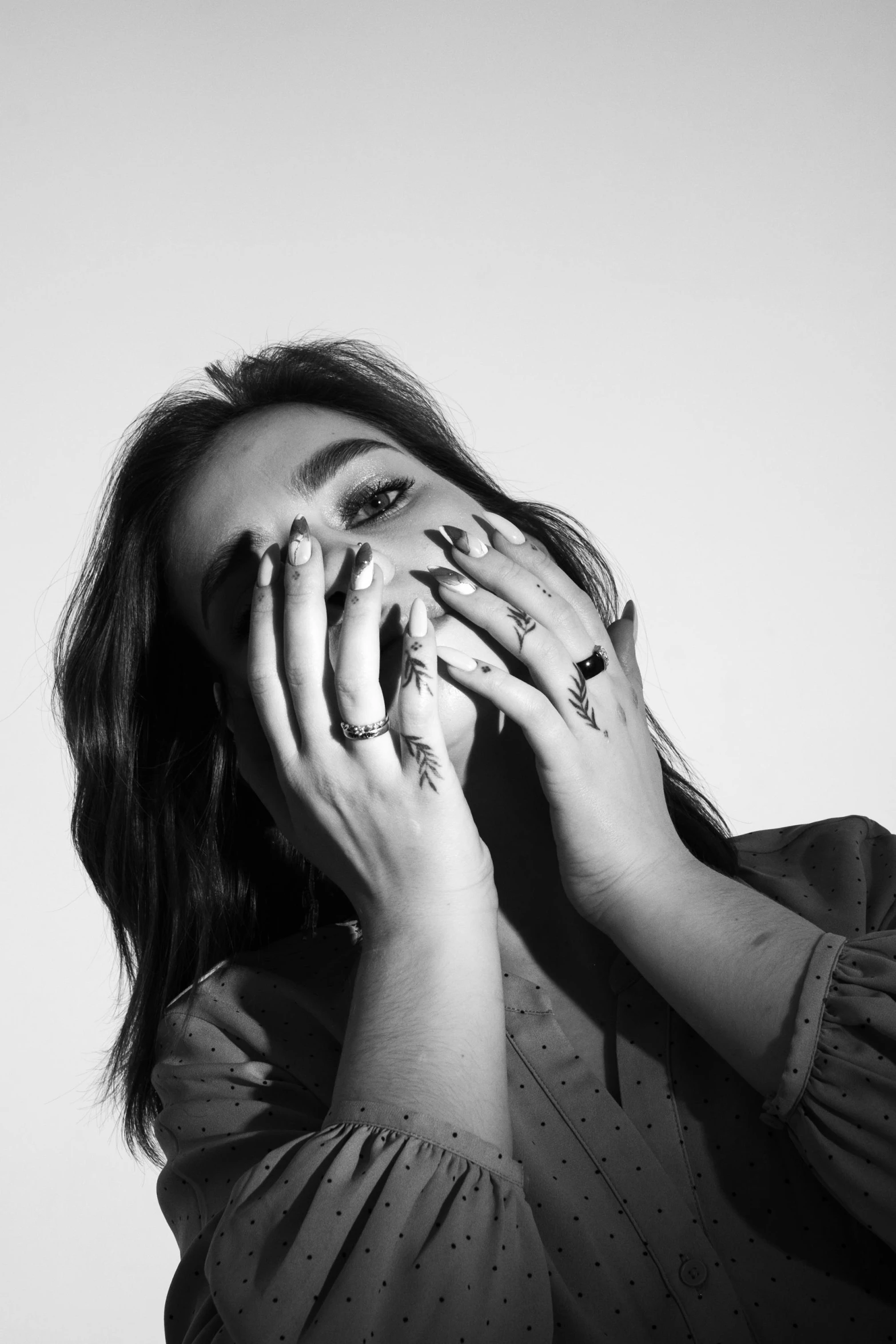 a woman covering her eyes with her hands