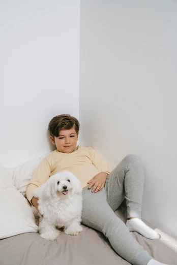 a boy and his dog sit in their room