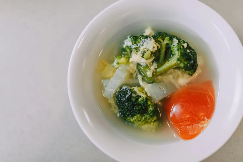 a bowl filled with meat and broccoli and a garnish