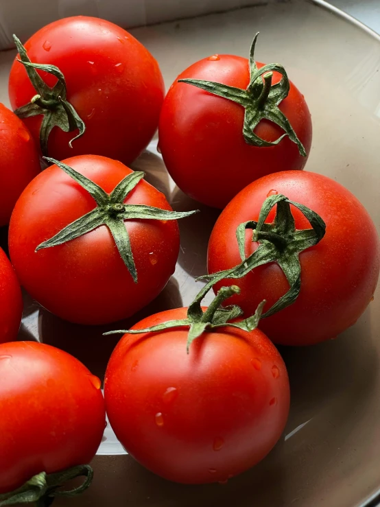 bunches of tomatoes in a white bowl