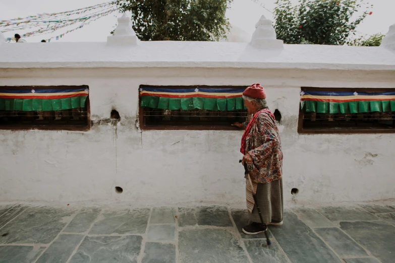 a person leaning against a building while standing