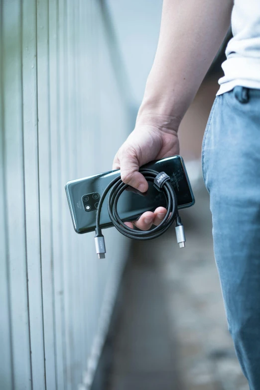 person holding a power strip and charging it into a box