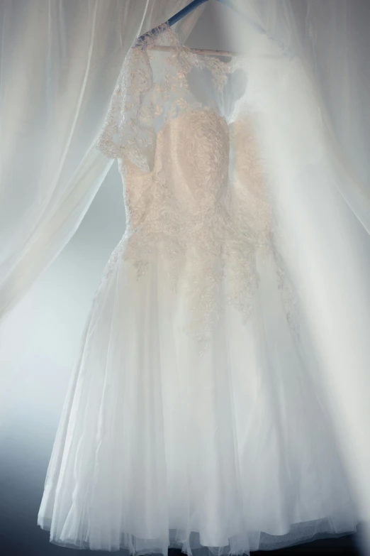 a wedding dress with some type of fabric attached to the dress