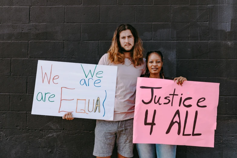 two girls holding signs that say we are we are family