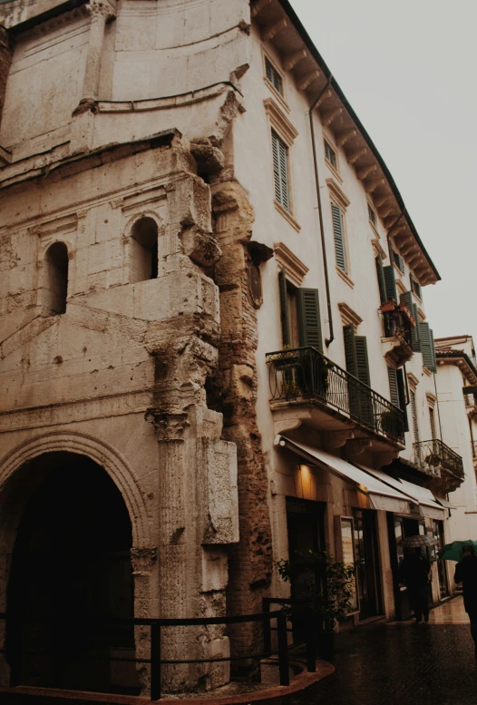 an old building with balcony over looking a street