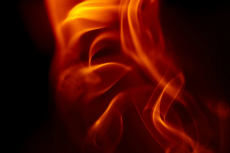 a dark background of fire that looks like it has orange and red flames