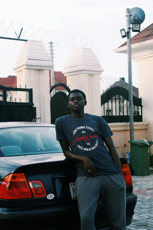 a man standing by the trunk of his car