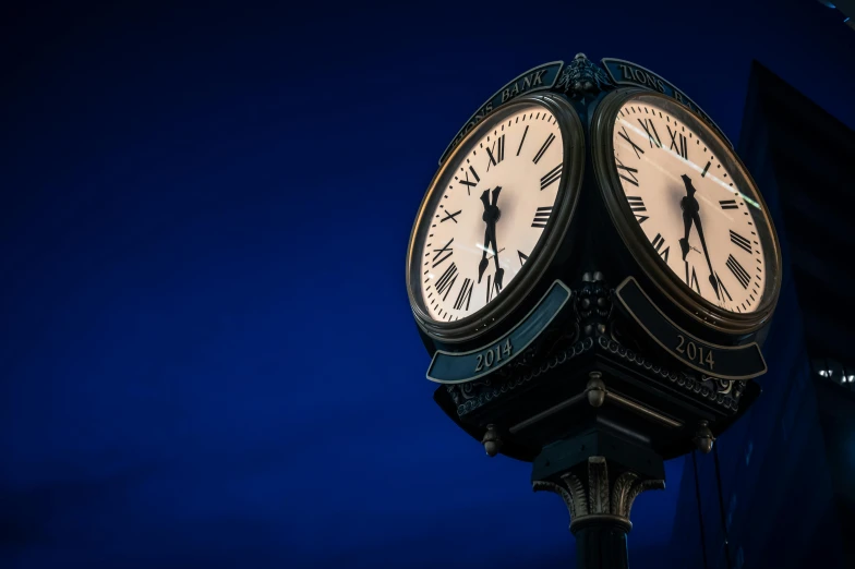 a close up of a clock tower against a blue sky