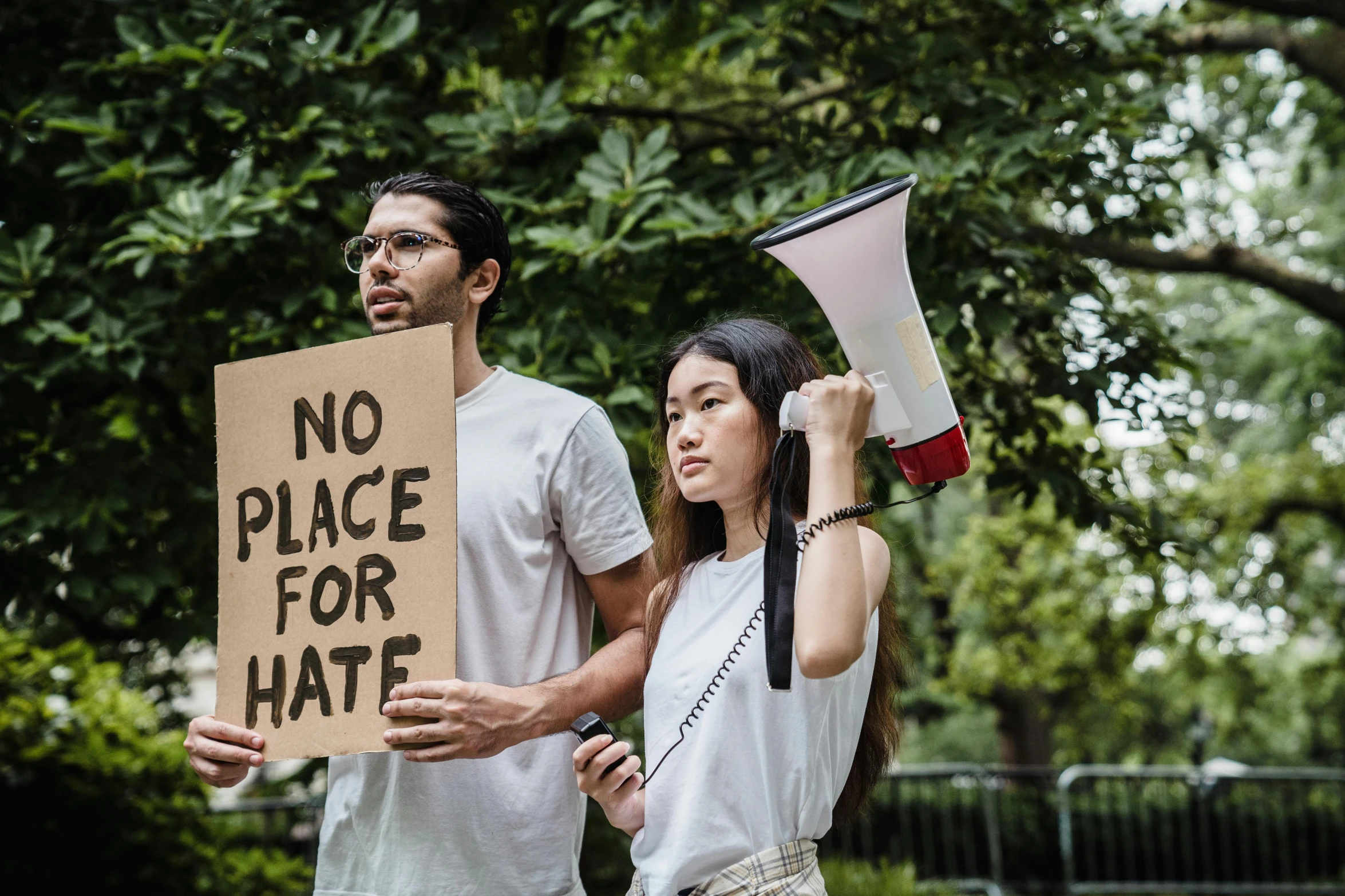 a man holding up a sign in front of another