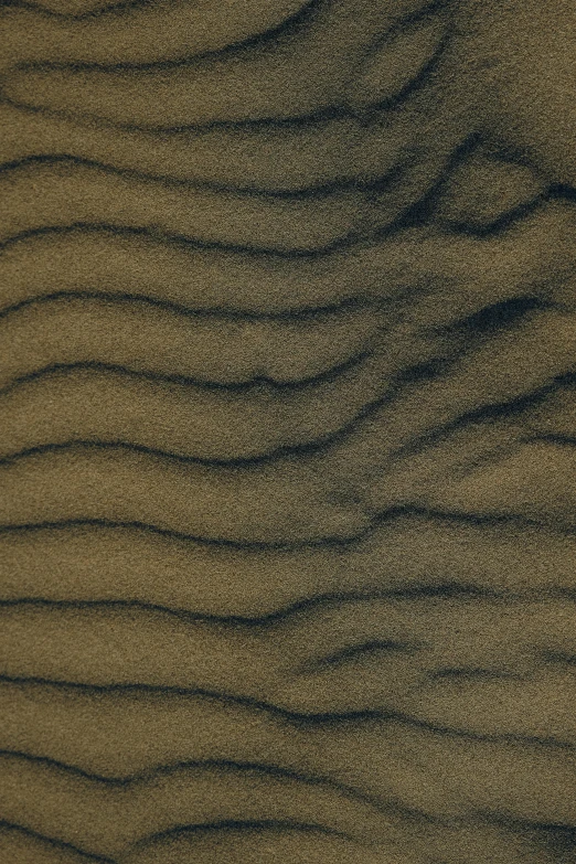 a very close up view of sand that looks like wavy lines