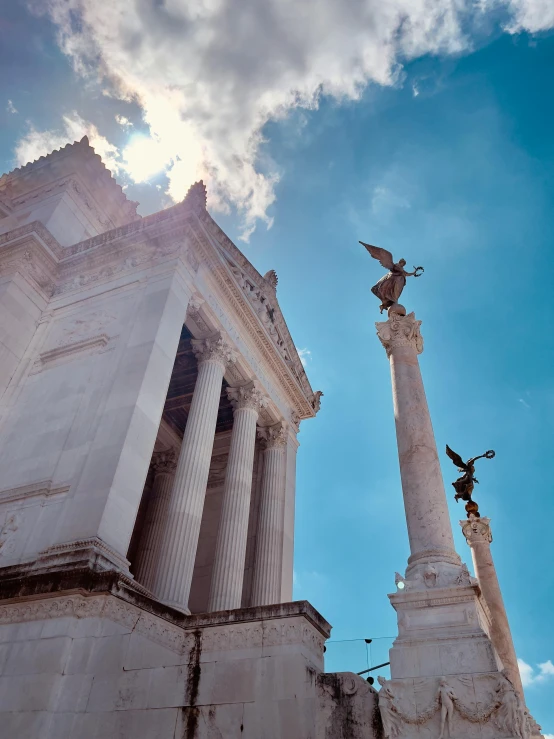 an ancient building with statues surrounding it