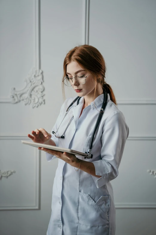 a nurse wearing glasses holding soing in her hand