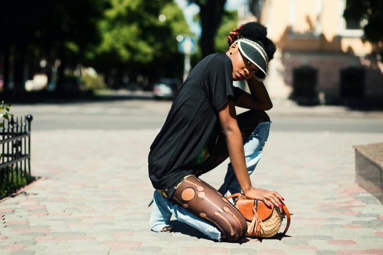 there is a male with his hat on kneeling down