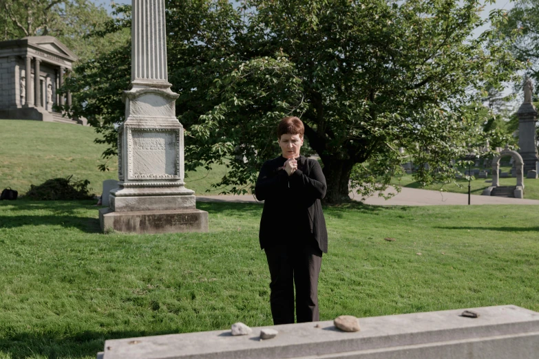 a woman standing on top of a green field