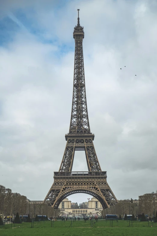 the eiffel tower is shown on a cloudy day
