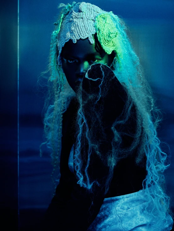 a woman with green hair dressed as a wizard