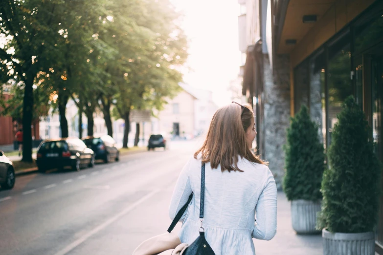 a woman standing in the street looking out into the distance