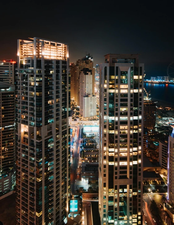 many buildings are lit up at night in the city