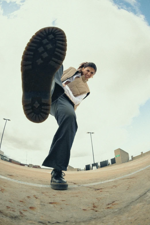 man standing with a skateboard up against his back