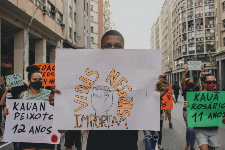 the protestors are holding up a placard with images on it