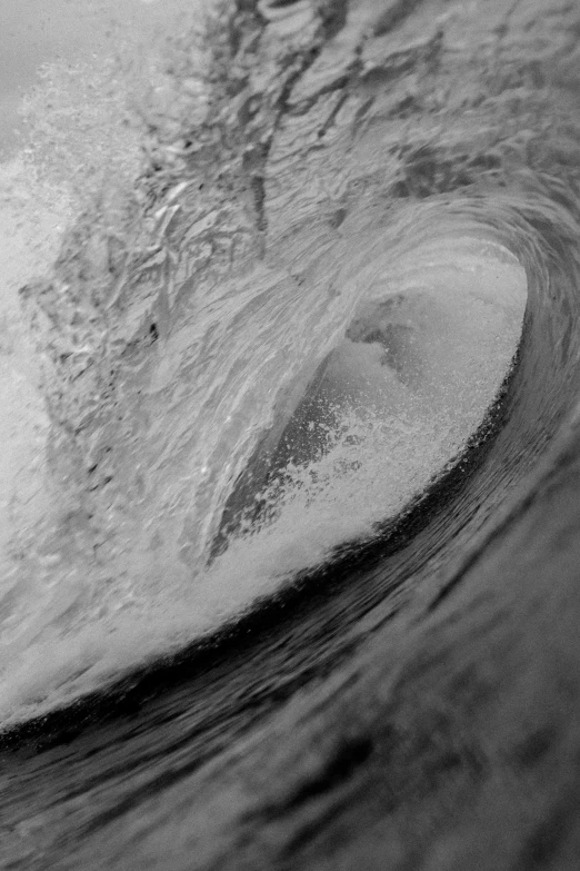 black and white pograph of a wave rolling