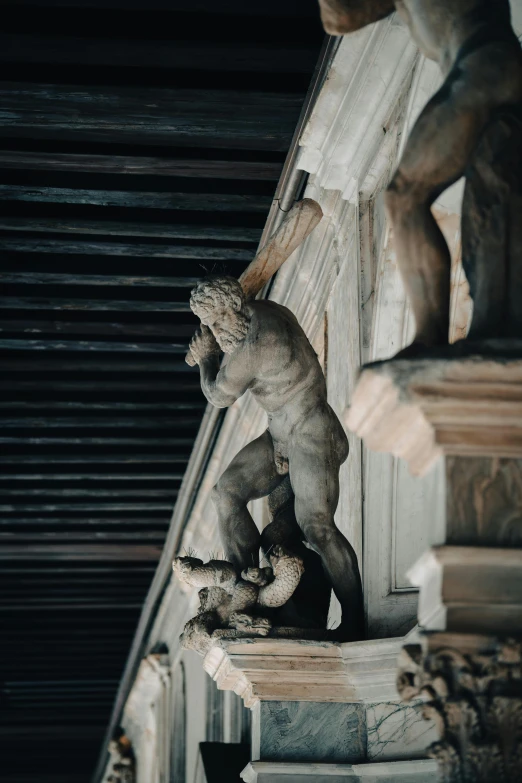 the statue is posed on the top of a building