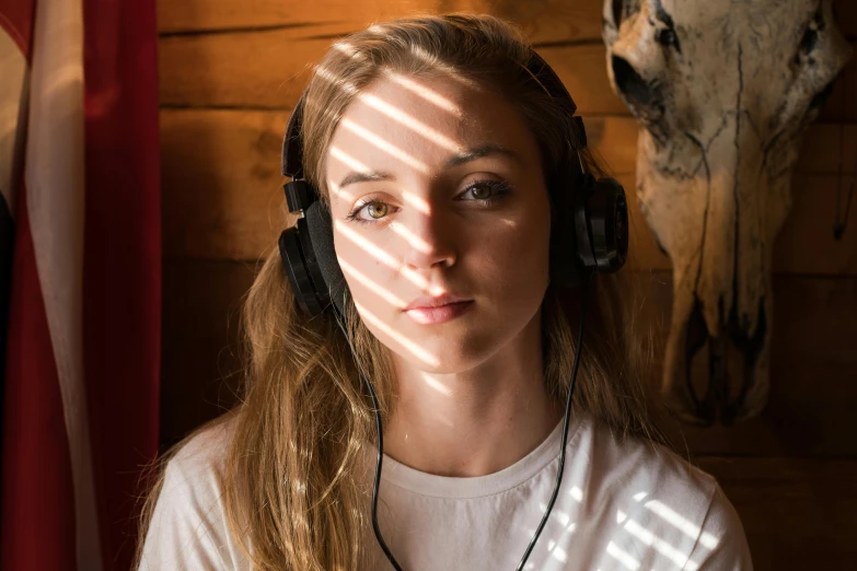 the girl in white t - shirt wearing headphones