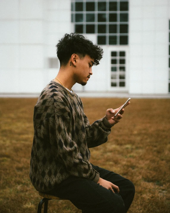 a person sitting down using a cell phone