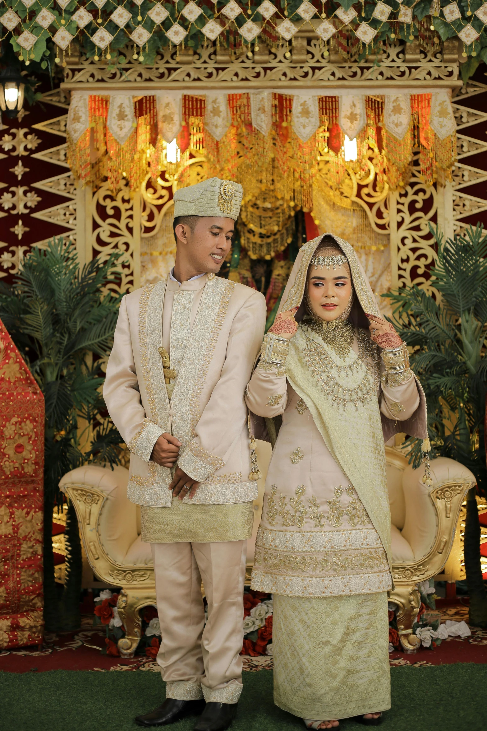 a bride and groom in white standing next to each other