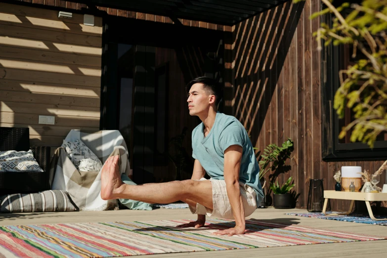 a man sitting on the ground holding a skateboard