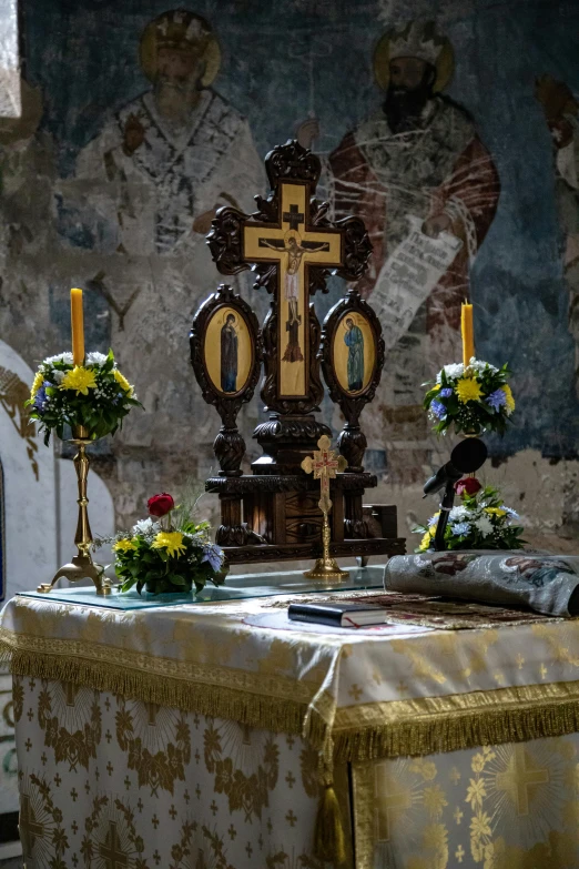 the altar is decorated with yellow flowers and candles